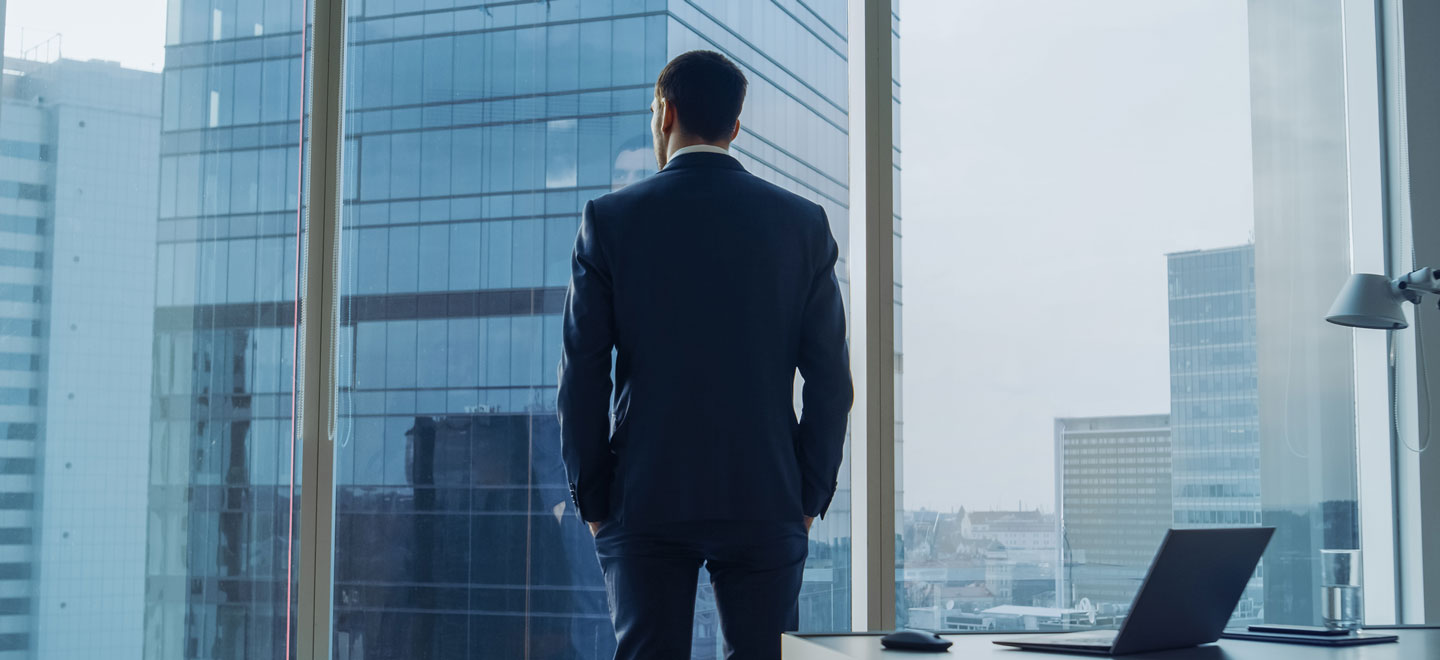 A businessman overlooking the city in his office