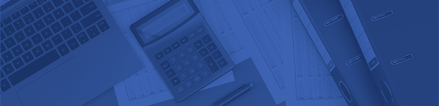 An overhead view of a laptop and calculator