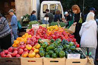 A stand of vegetables at a farmers market.