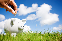 Putting money in a piggy bank.